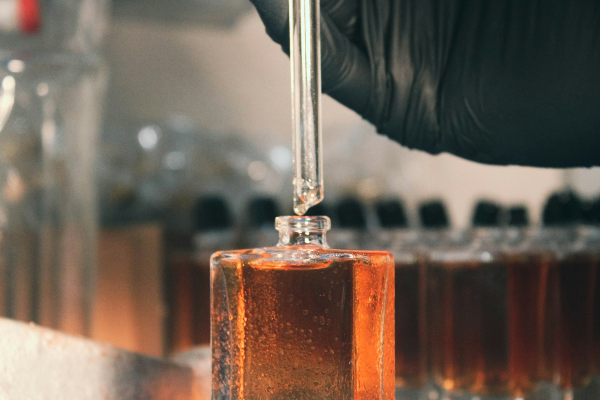 a person in a lab coat is holding a test tube with liquid in it a person in a lab coat is holding a test tube with liquid in it